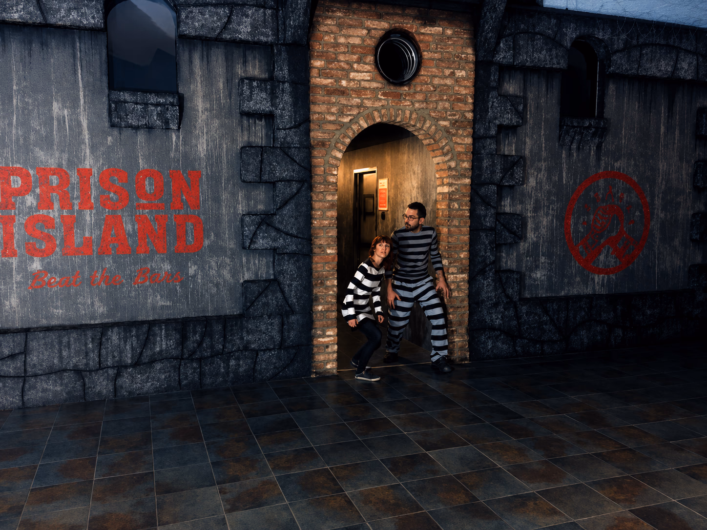 Players in prison stripes at the door of a Prison Island challenge cell.