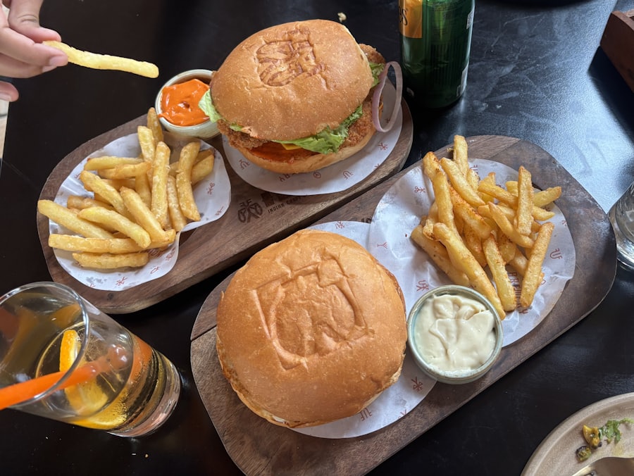 Burgers and chips served on boards.