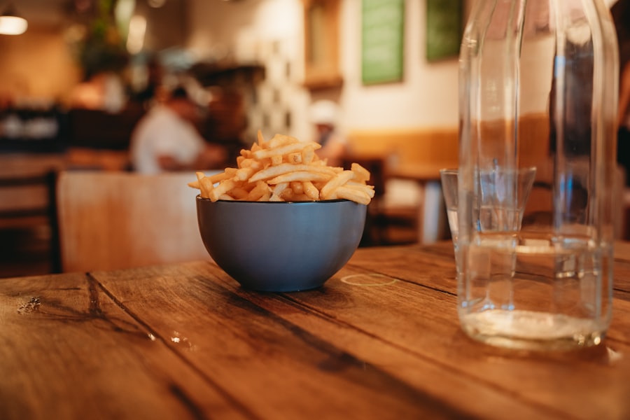 A bowl of chips on a wooden table.