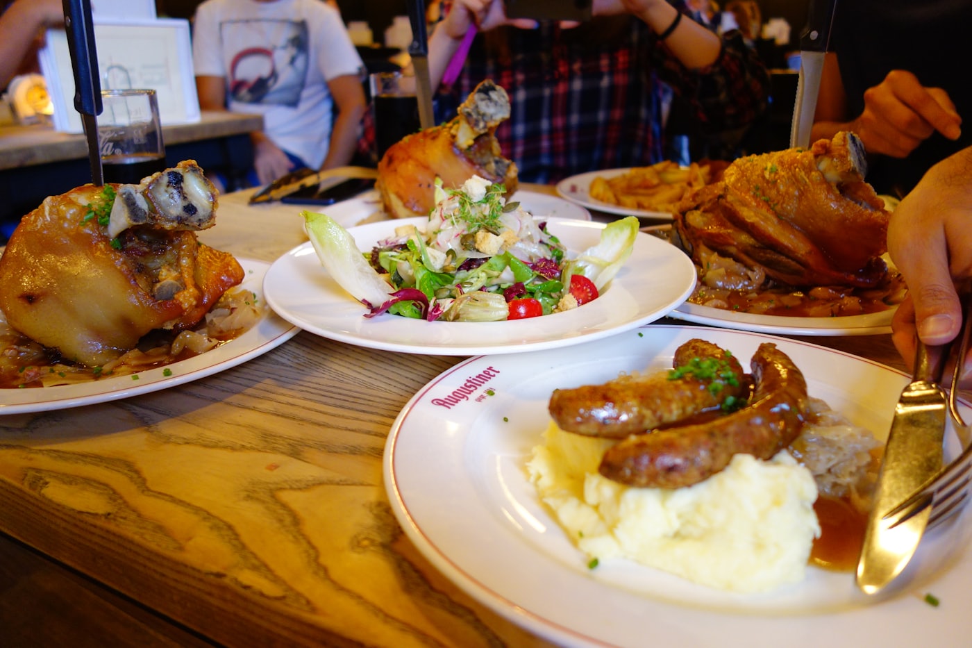A table laid with plates of food being shared between guests.