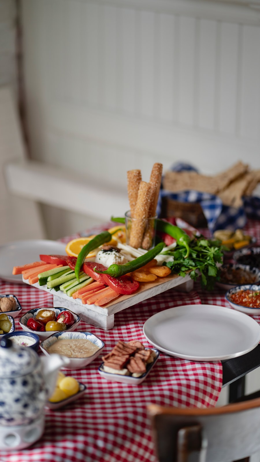 A sharing platter on the table with guests behind it.