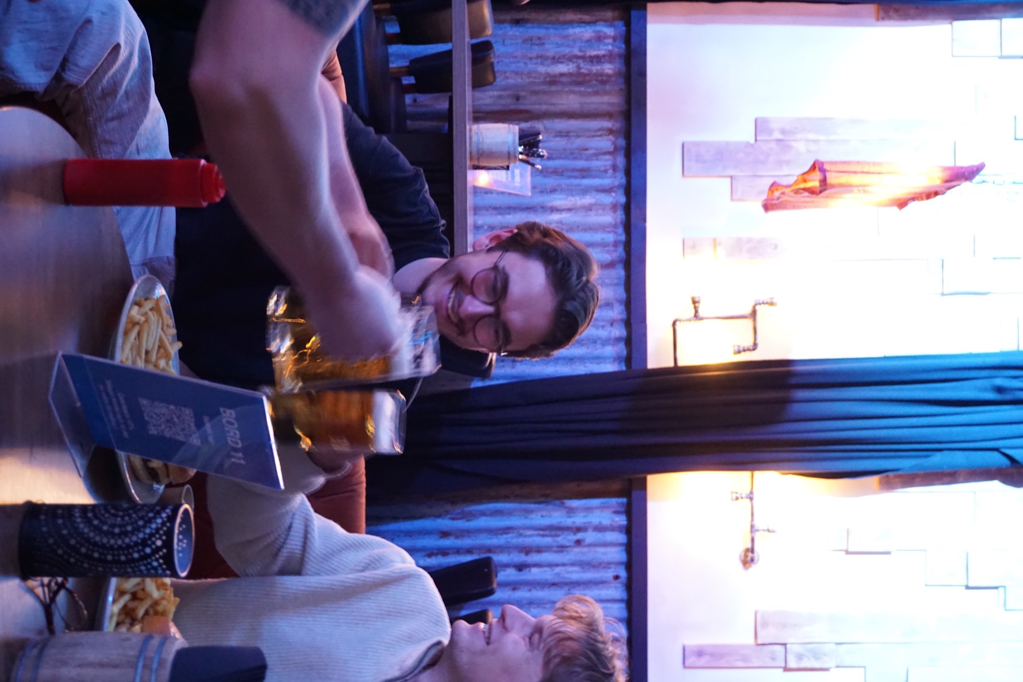 Guests raising a glass together over food at Murphy's Cellar.