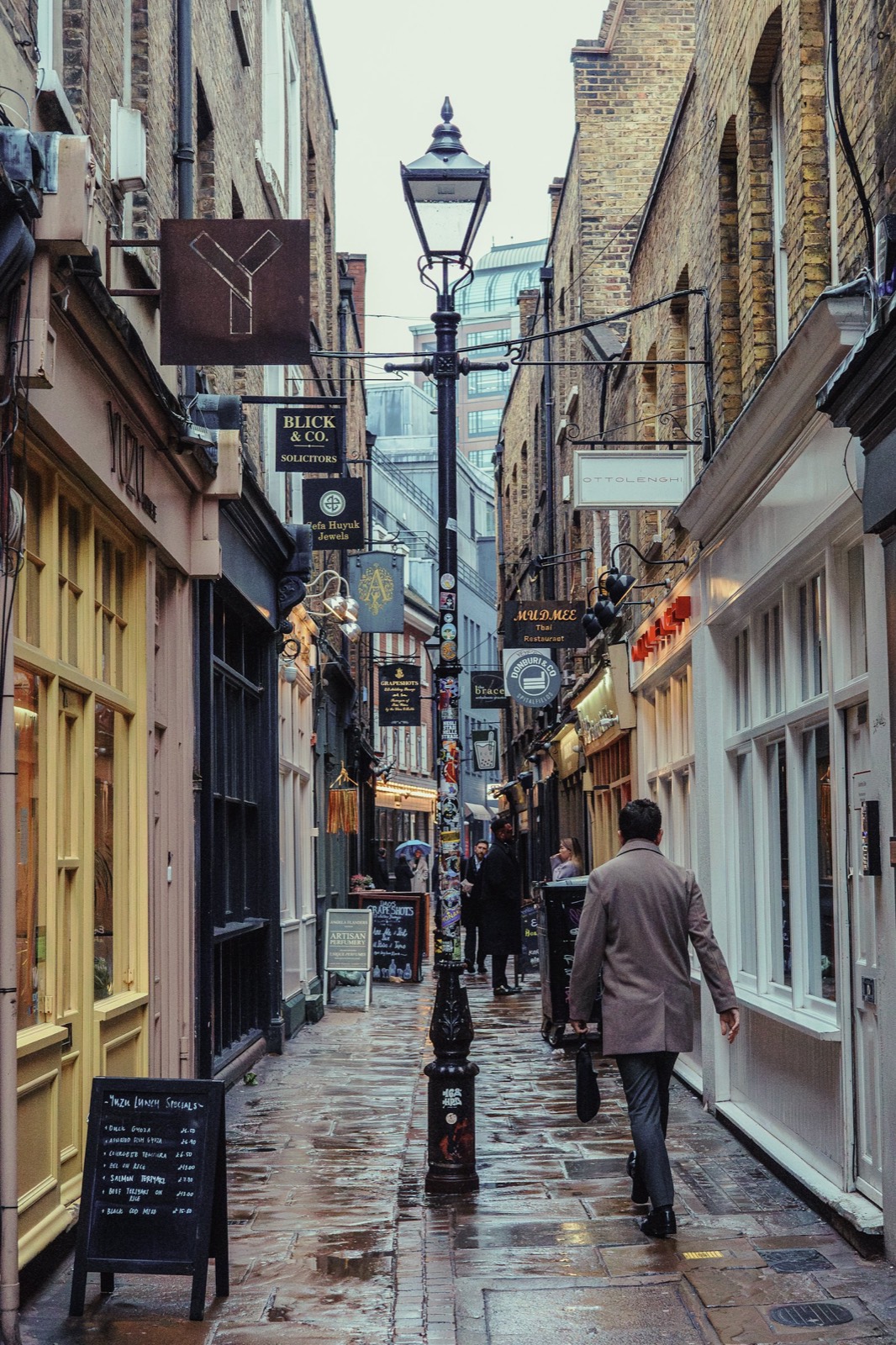 A narrow London street lined with old shopfronts.