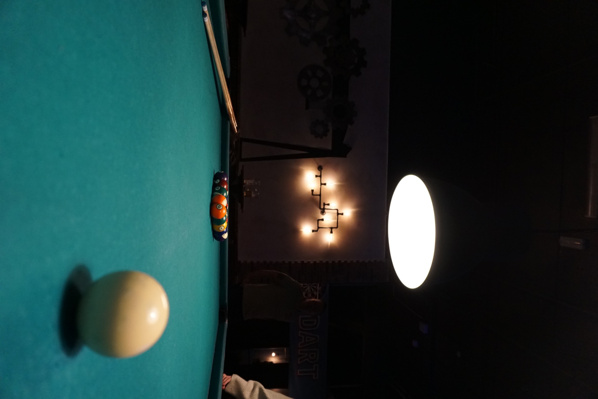 A pool table under a low lamp at Murphy's Cellar.